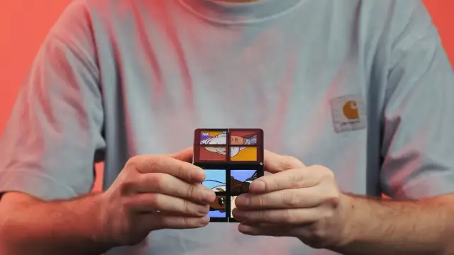 hands holding cube